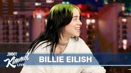 Billie eilish on Jimmy kimmel live talk show smiling at the host 